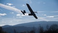 Drone airplane, low altitude passage, sunny sky with clouds Royalty Free Stock Photo