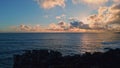 Drone amazing evening seascape on rocky shore. Sunset light reflecting in ocean