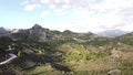 Drone ascendance flight in mountains, road in frame