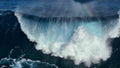 Drone barreling wave with texture and wind spray. Aerial shot of breaking surf with foam in Pacific Ocean. Powerful