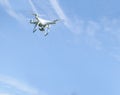 Drone with camera flying on a clear sunny sky background Royalty Free Stock Photo