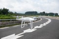 Drone with camera flying over highway Royalty Free Stock Photo