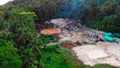 Drone Captures Waste Incineration in Tropical Paradise. Witness waste management on landfill as drones reveal the impact