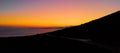 DRONE: Car disappearing in the distance as it drives around Lefkas at sunset. Royalty Free Stock Photo