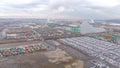 DRONE: Circling around a massive port full of cargo containers on a cloudy day.