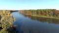 Drone crane shot rising over the water on the river in Rosemere on a clear sunny day of Autumn