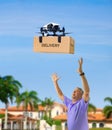 Drone delivering box package on delivery flight to a happy waiting man with outstretched arms