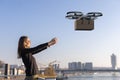 drone delivers a box to woman