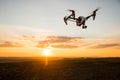 drone with digital camera flying in sky over field on sunset Royalty Free Stock Photo