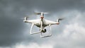 Drone DJI Phantom 4 in flight. Dron against the cloudy sky. The flight of the drone before a thunderstorm. The flight of the Royalty Free Stock Photo