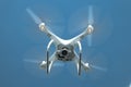 Drone DJI Phantom 4 in flight. Quadrocopter against the blue sky Royalty Free Stock Photo