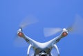 Drone DJI Phantom 4 in flight. Quadrocopter against the blue sky Royalty Free Stock Photo