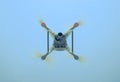 Drone DJI Phantom 4 in flight. Quadrocopter against the blue sky Royalty Free Stock Photo