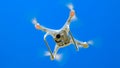 Drone DJI Phantom 4 in flight. Quadrocopter against the blue sky Royalty Free Stock Photo