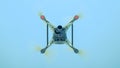 Drone DJI Phantom 4 in flight. Quadrocopter against the blue sky Royalty Free Stock Photo