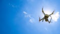 Drone DJI Phantom 4 in flight. Quadrocopter against the blue sky Royalty Free Stock Photo