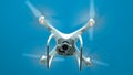 Drone DJI Phantom 4 in flight. Quadrocopter against the blue sky Royalty Free Stock Photo