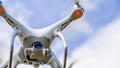 Drone DJI Phantom 4 in flight. Quadrocopter against the blue sky with white clouds. The flight of the copter in the sky Royalty Free Stock Photo