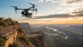 A drone equipped with a camera hovers over scenic cliffs during sunset Royalty Free Stock Photo
