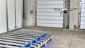 A drone equipped with an RFID reader flying above a line of pallets seamlessly scanning each item for inventory tracking Royalty Free Stock Photo