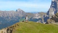 DRONE: Female tourist stops at the mountaintop to take pictures of the landscape Royalty Free Stock Photo