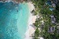 Drone field of view of coastline and houses with spectacular blue bay on Praslin, Seychelles