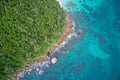 Drone field of view of turquoise blue waters meeting coastline Praslin, Seychelles