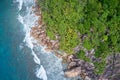 Drone field of view of waves crashing into cliffs along coastline Praslin, Seychelles