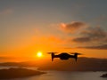 Drone filming the sea and mountains at sunset