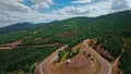 Drone filming a winding road on a mountainside that wriggle through a dense forest in Wyoming