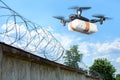 The drone flew across the sky with smuggling. The drone transports forbidden goods across the border breaking the law. Delivery of