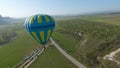 Drone flies by balloons. Shot. Top view of beautiful balloons up close. Balloon festival over green fields and rock on