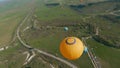 Drone flies by balloons. Shot. Top view of beautiful balloons up close. Balloon festival over green fields and rock on