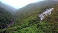 Drone Flies from Gorge with River to Tableland with Waterfall