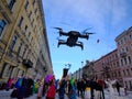 Drone flies low in the center of the city and leads photo and video filming at a city festival. Black color