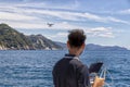 Drone flies over the sea under the control of the professional operator