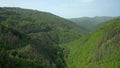 Drone flight above green mountain slopes