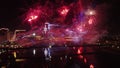 Drone flight through the holiday fireworks above water with reflection. Statehood Day, Independence Day. 4K