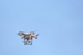 A drone in flight, carrying a camera. Royalty Free Stock Photo