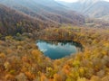 Drone flight over a hidden Gosh lake in the Armenian autumn forests