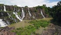 Drone flight over a natural park with picturesque waterfall cascade and greneery