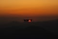 Drone in flight. Silhouette of an UAV quadcopter flying in front of the sun during sunset Royalty Free Stock Photo