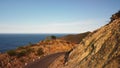 Drone fly over a cliffside highway with car and motorbikes running.