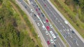DRONE: Flying above cars moving along entry lane during a traffic jam on highway