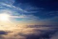 Drone flying above clouds with a beautiful sun in the sky Royalty Free Stock Photo