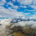 Drone flying above clouds with a beautiful sun in the sky Royalty Free Stock Photo