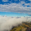 Drone flying above clouds with a beautiful sun in the sky Royalty Free Stock Photo