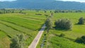 DRONE: Flying above a group of road cyclists riding their bikes down the road. Royalty Free Stock Photo