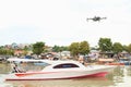 Drone flying above speedboat on river in Manado