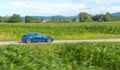 DRONE: Flying along a high tech car driving itself down the country road. Royalty Free Stock Photo